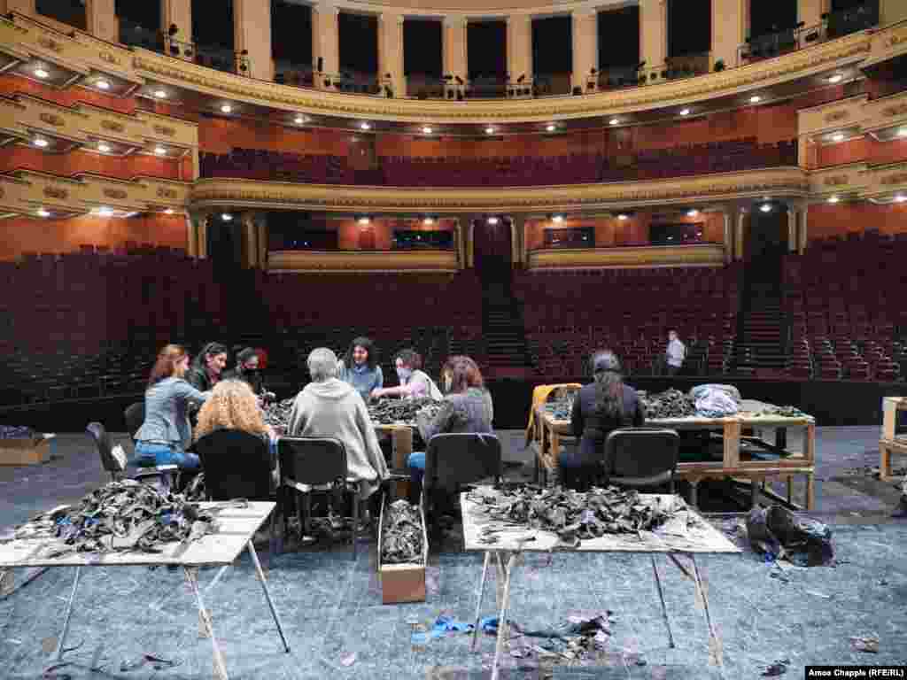 Women at work on the stage of the Opera Theater on October 29 &nbsp; David Aghajanian, who organized the use of the theater, told RFE/RL that there are more than 700 people working on 25 such operations in public buildings throughout Yerevan. Work inside the opera theater began five days ago.