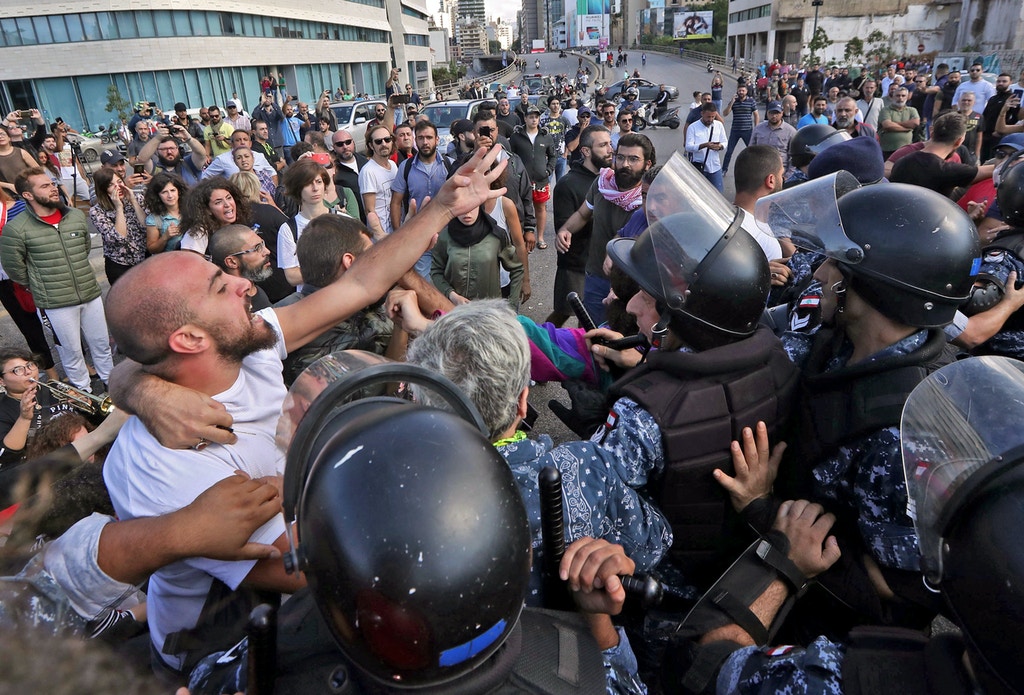 Lebanese security forces contain clashes between demonstrators and counter-protesters in the centre of the capital Beirut during the 13th day of anti-government protests on October 29, 2019. - Dozens of rioters descended on to Riad al-Solh Square near the government headquarters in Beirut, where they attacked protesters, torched tents, and tore down banners calling for "revolution", said an AFP correspondent in the area. The unprecedented attack on the main site of the capital's largely peaceful protest movement forced the army and riot police to deploy en masse to contain the violence (Photo by - / AFP) (Photo by -/AFP via Getty Images)