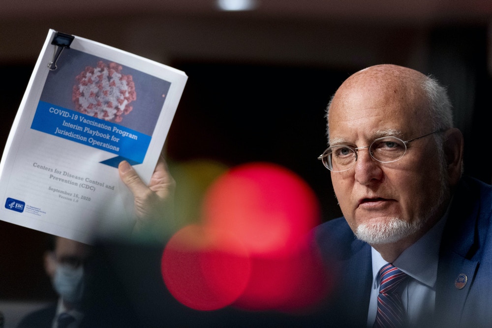 Robert Redfield, director of the Centers for Disease Control and Prevention (CDC), speaks while holding up documents during a Senate Appropriations subcommittee hearing on Capitol Hill in Washington, D.C., U.S., on Wednesday, Sept. 16, 2020. Preparations are underway to ensure that vaccines against Covid-19 will be shipped to administration sites within 24 hours of clearance by U.S. regulators, health officials said. Photographer: Andrew Harnik/AP Photo/Bloomberg via Getty Images