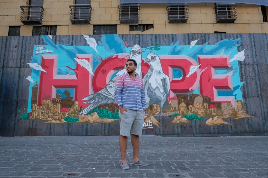 Ahmad Tahan posing in front of a recent graffiti of 'HOPE': An October Revolution activist and filmmaker who was heavily involved in last year’s protests and has been volunteering on the ground every day since the August 4 blast.