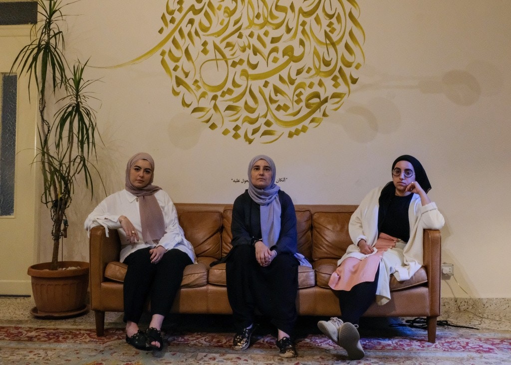 Aya Zantout, Jude Chehab and Hiba Khoda posing on the sofa under their meaningful symbol inside Al Makan center.