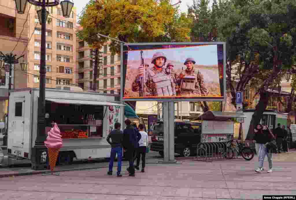 A television plays a loop of soldiers and military exercises in downtown Yerevan on October 28.&nbsp;
