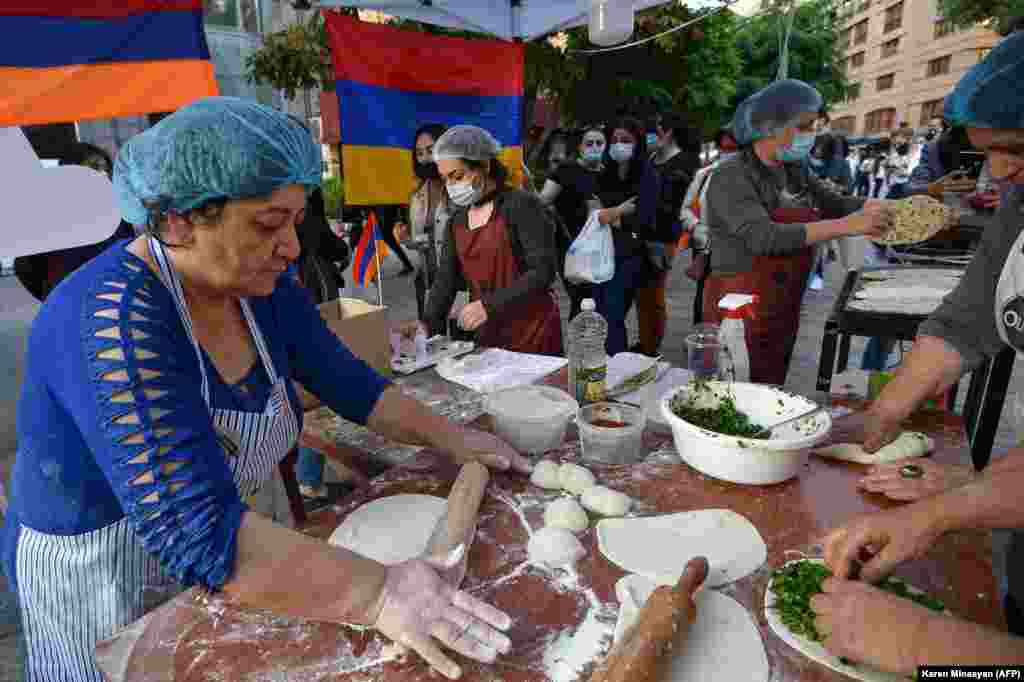 Refugees who fled the Nagorno-Karabakh region make jingalov hats&nbsp;-- traditional flatbreads stuffed with herbs, in central Yerevan on October 26.&nbsp;