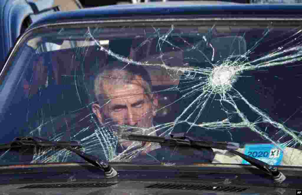 A passenger waits as his car is searched at a checkpoint while leaving Nagorno-Karabakh on November 8.&nbsp;