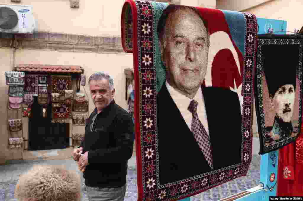 A man selling carpets with the image of former Azerbaijani President Heidar Aliyev (left) and Mustafa Kemal Ataturk, the founder of modern Turkey. Aliyev famously described Turkey and Azerbaijan as&nbsp;&quot;one nation, two states.&quot;&nbsp;