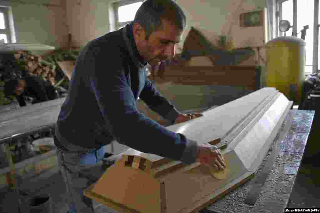 A man makes a coffin at a furniture workshop in Stepanakert on November 4. The company switched its business to casket production amid the ongoing military conflict between Armenia and Azerbaijan in Nagorno-Karabakh.&nbsp;