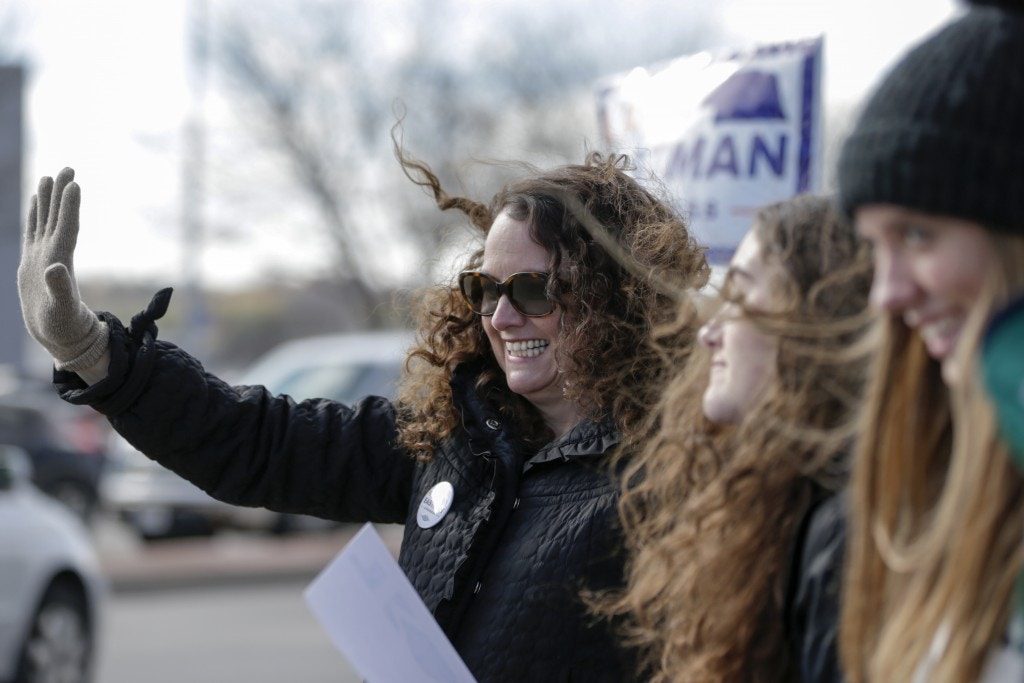 Democratic House candidate Kara Eastman waves to passing motorists in Omaha, Neb., on Nov. 6, 2018.