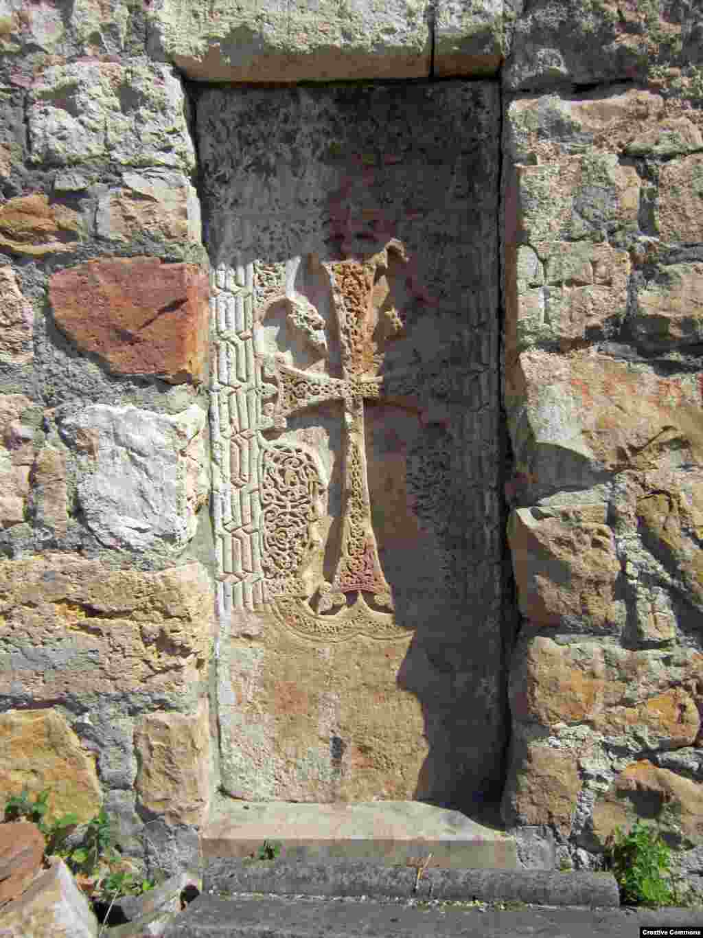 A detail of a carved stone cross (visible just right of center in the previous photo) near the entrance to Gtichavank. The monastery was completed in 1248. &nbsp;