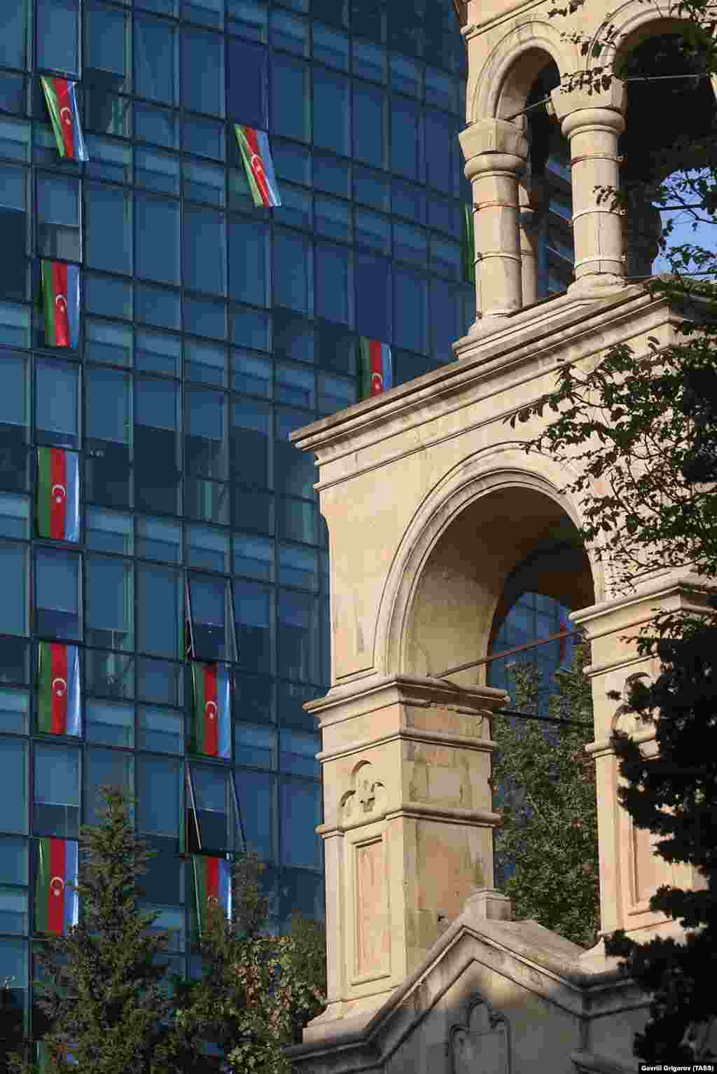 St. Gregory the Illuminator Church (right) and the offices of the International Bank of Azerbaijan adorned with national flags on November 4.&nbsp;