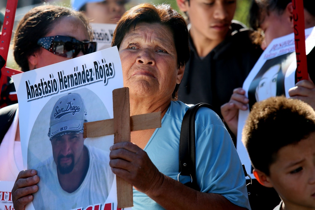 Maria de la Luz stands with a picture of her son Anastasio Hernandez Rojas, who was killed by a border Patrol agent, during a rally at the U.S.-Mexico border in San Ysidro, California on Saturday, February 23, 2013. Approximately Two hundred activists from several Latino organizations met at the border to protest several deaths and beating caused by Customs and Border Protection agents. (Photo by Sandy Huffaker/Corbis via Getty Images)