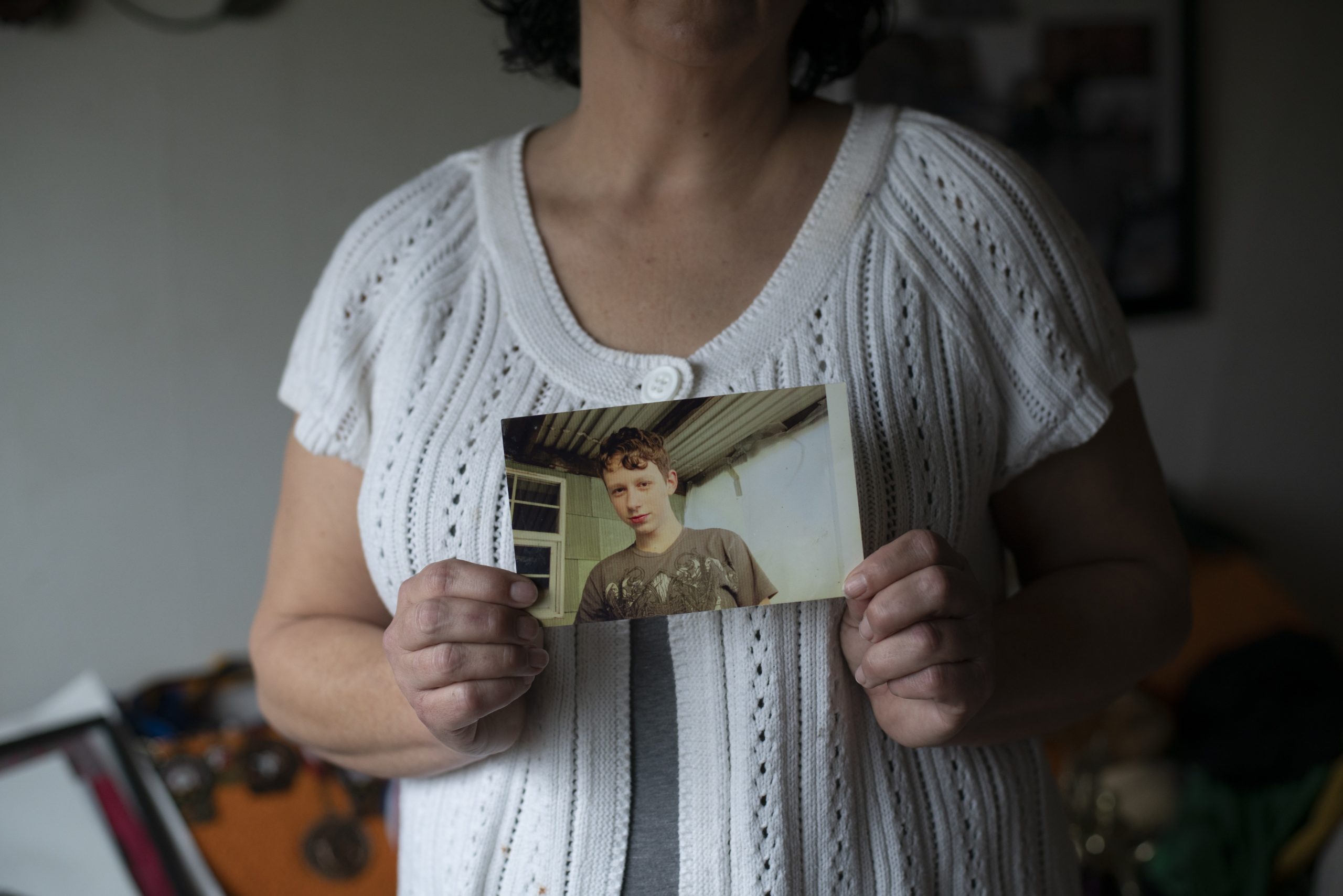 Laura Kealiher holds a snapshot of her son Sean Kealiher, a Portland activist killed in 2019 when he was 23, at her home in Portland, Oregon, on January 30, 2021. Brooke Herbert for The Intercept