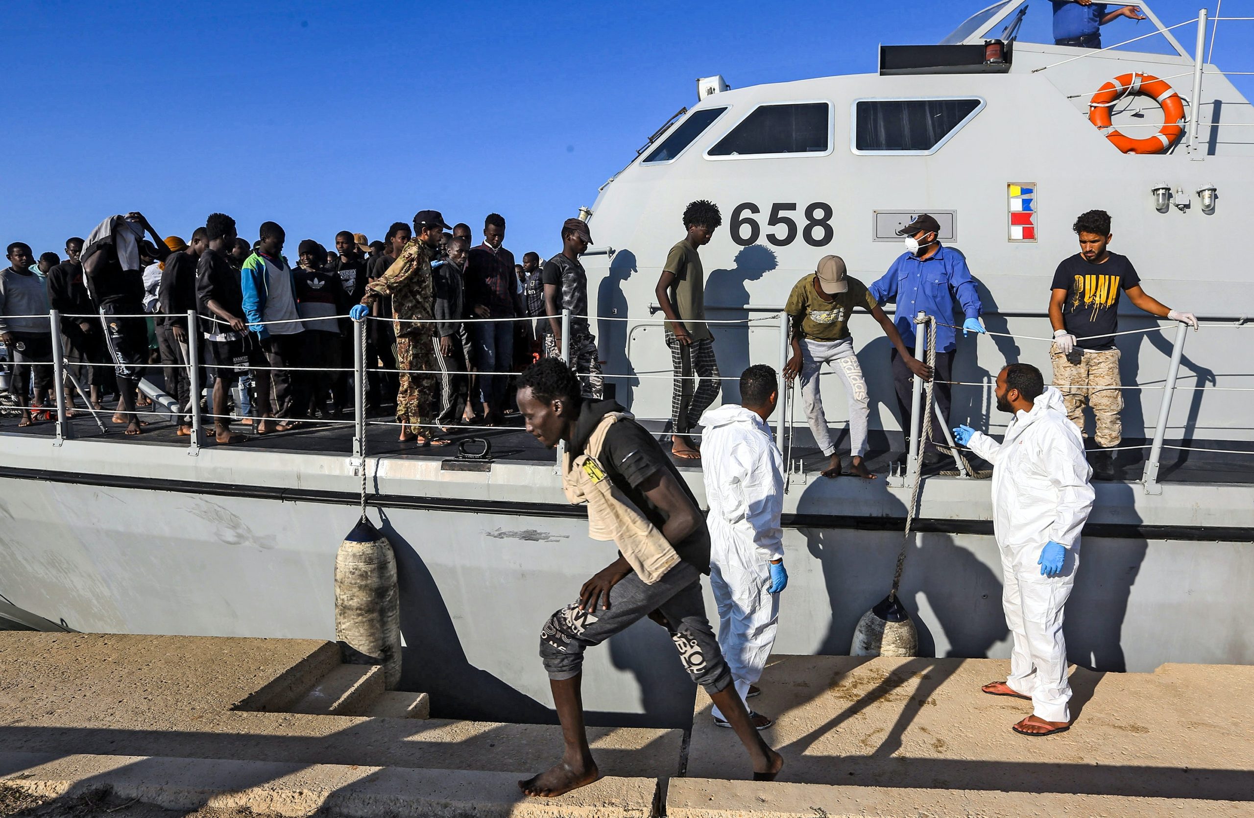 Rescued migrants disembarking from a Libyan coast guard ship in the town of Khoms, a town 120 kilometres (75 miles) east of the capital on October 1, 2019.