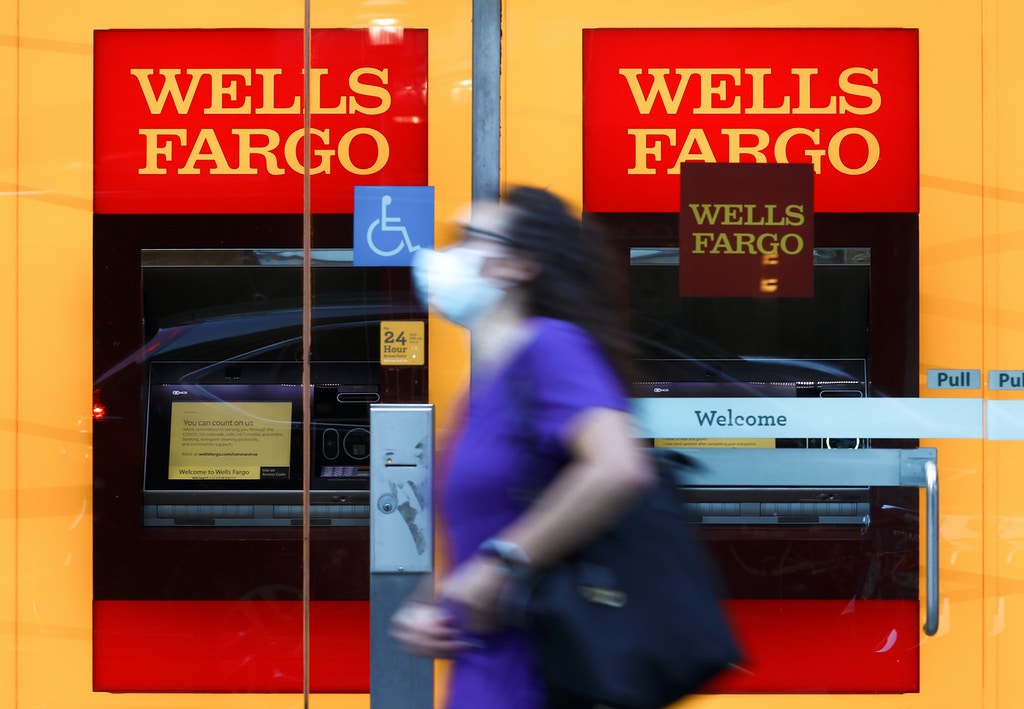 A pedestrian wearing a protective mask walks past a Wells Fargo & Co. bank branch in New York, on July 9, 2020.